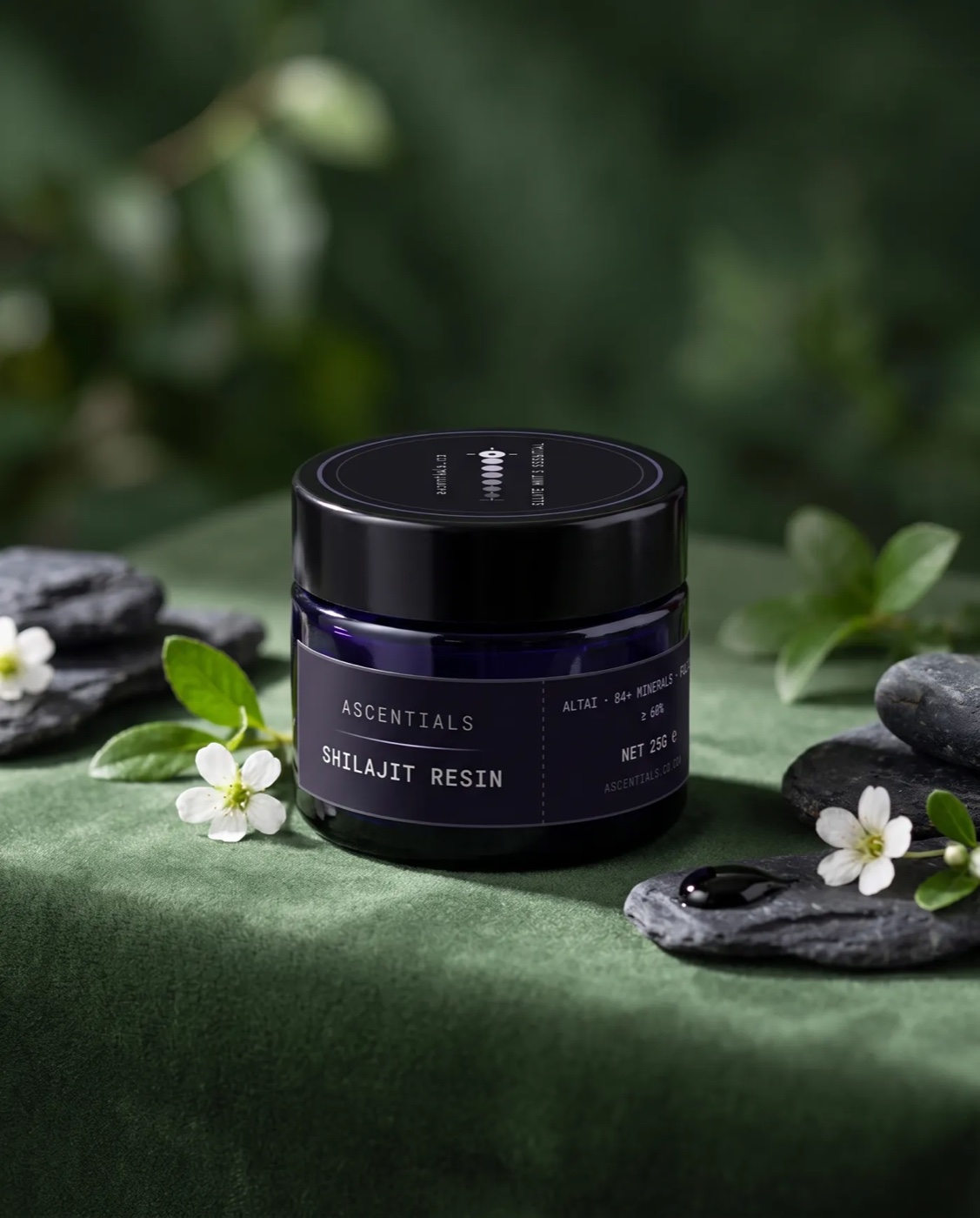ASCENTIALS Shilajit Resin jar on green velvet with stone and jasmine